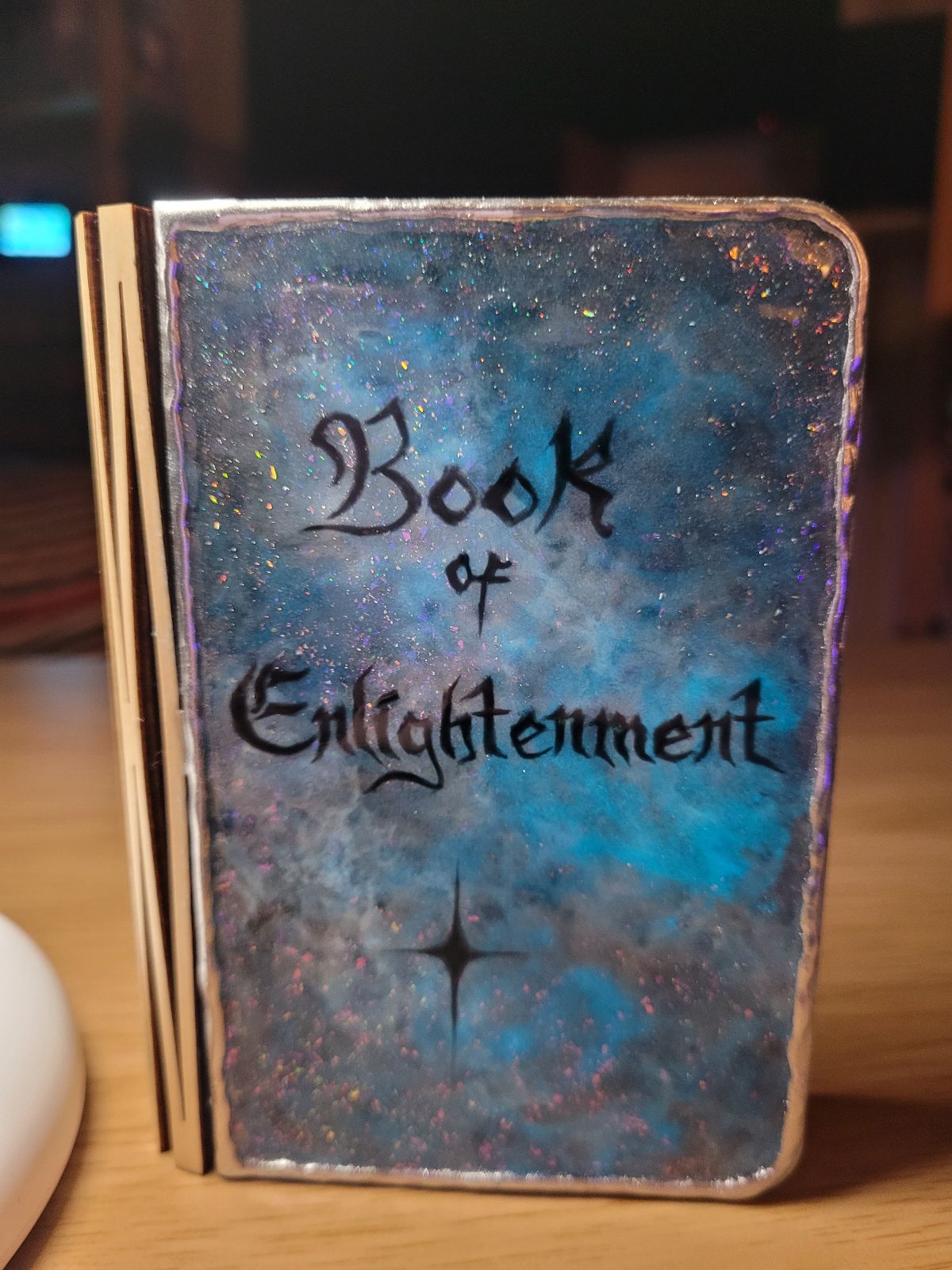 The same book, but the blue in the background is glowing brighter due to being viewed under UV light.