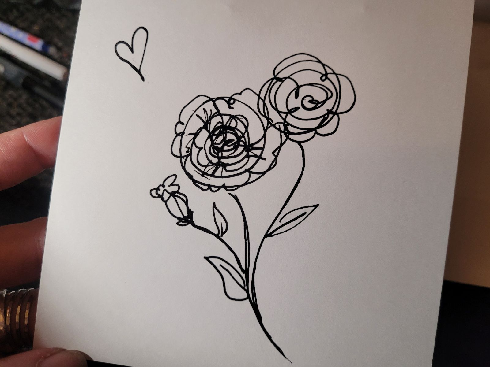 Gift card with a line sketch of two roses growing on the same stem.