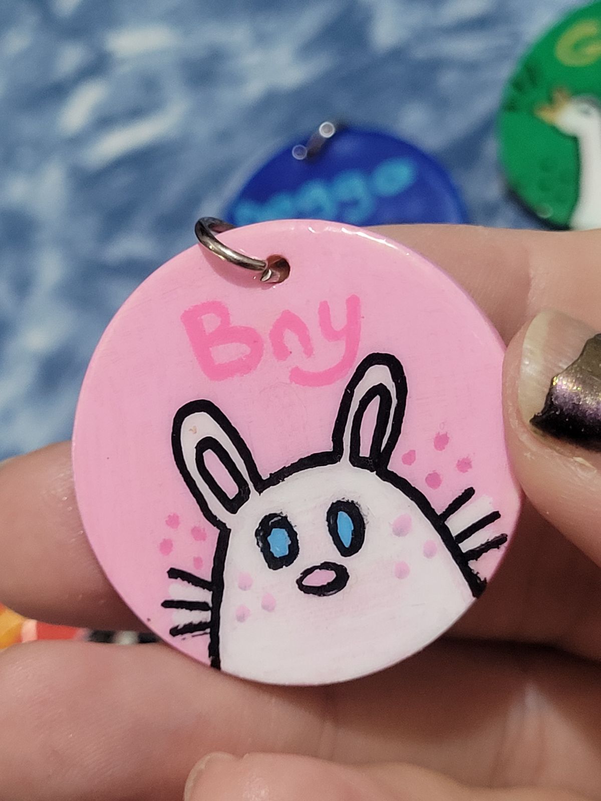 Cute white rabbit on a badge with 'Bny' written above in pink.