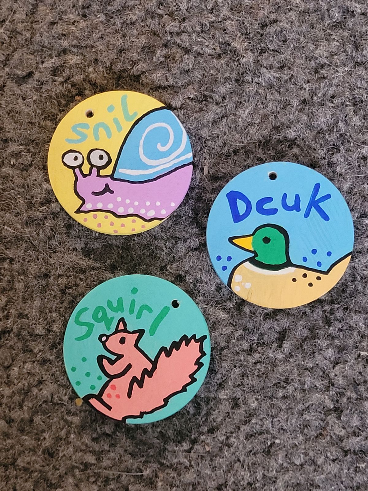 Snail (snil), Duck (dcuk) and Squirrel (squirl) cartoon animal badges.