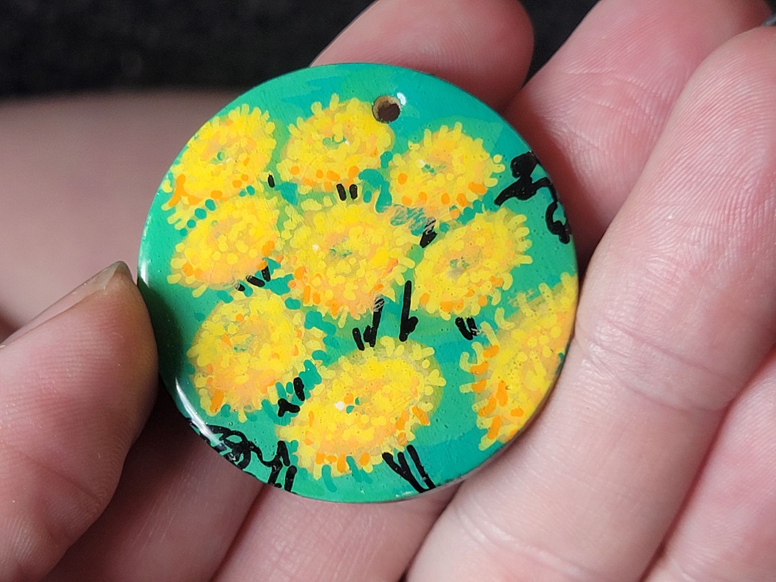 Badge featuring yellow tansy flowers.