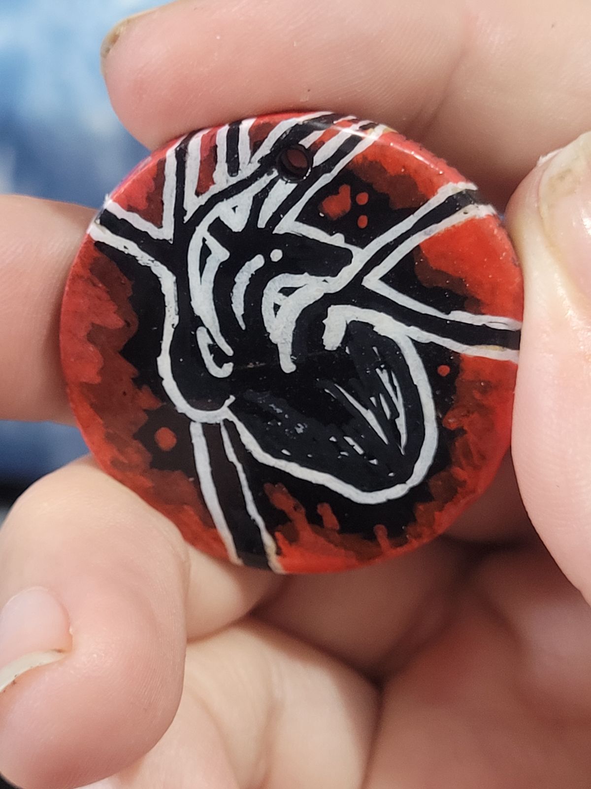 Badge showing an anatomical heart in black and white on a red background