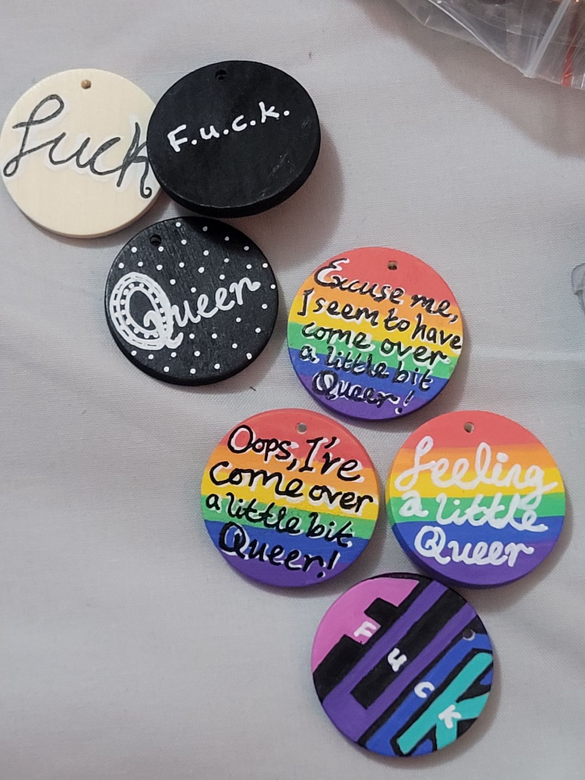 Variations on 'queer' badges.