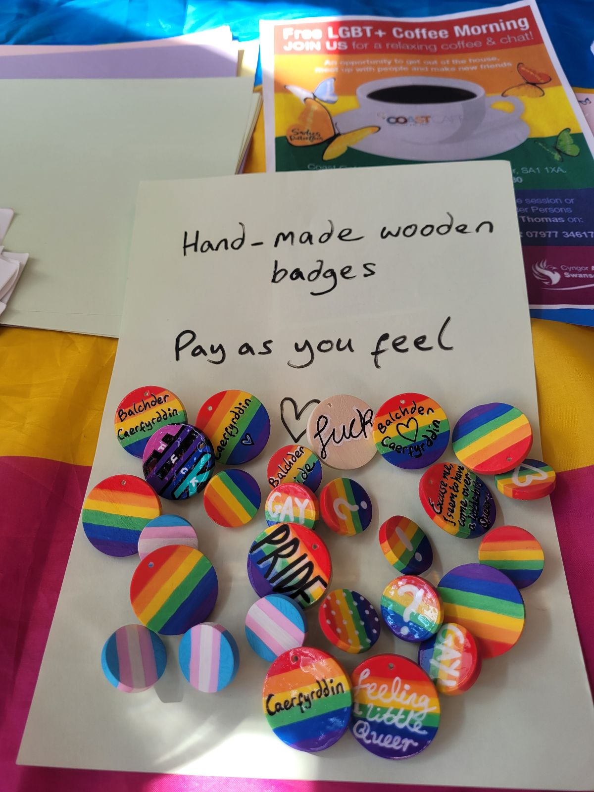 Badges laid out to be exchanged for donations to the pride festival.