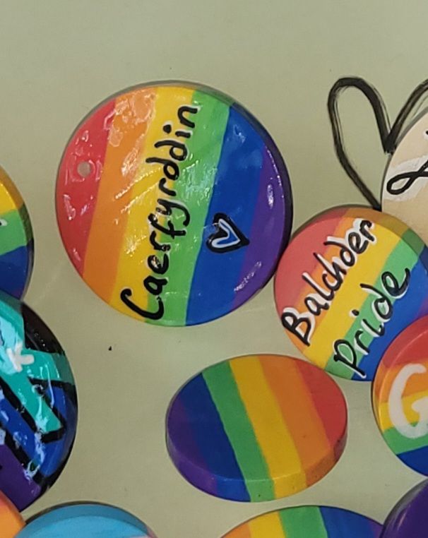 Rainbow badges reading 'Balcher' (pride in Welsh), and 'Caerfyrddin' (The local name for Carmarthen.