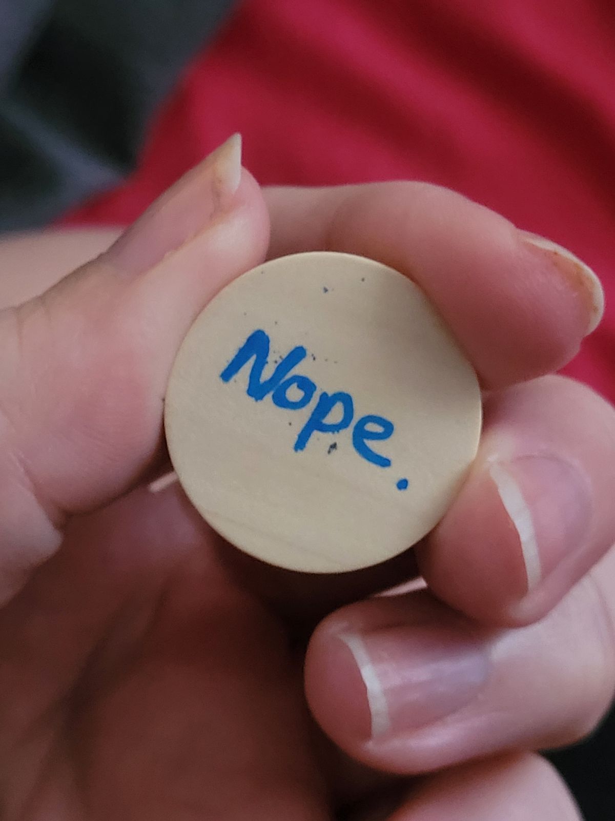 The family-friendly version of the fuck badges, just reads 'Nope'.