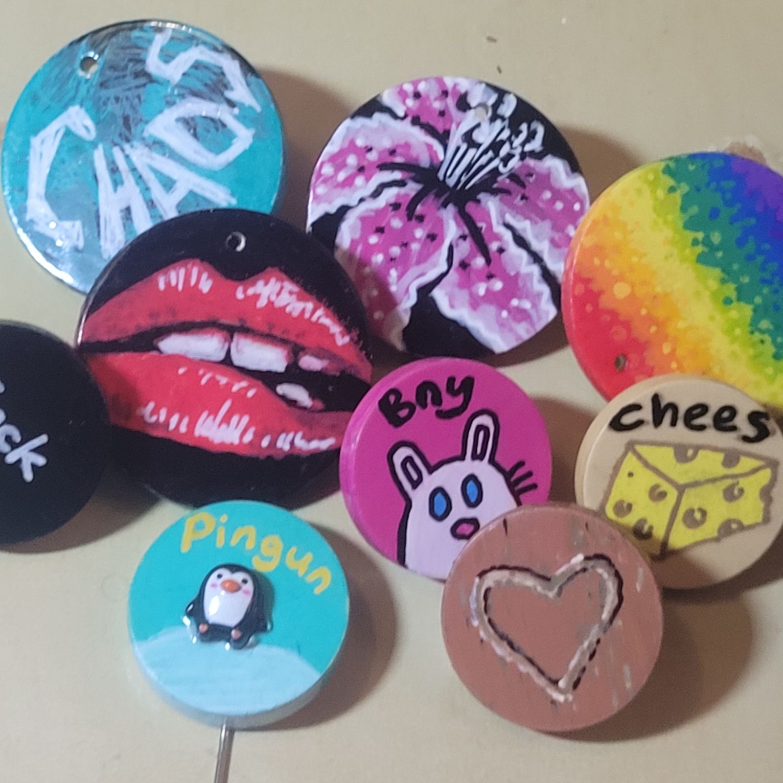 A selection of colourful badges with various, mostly image-based designs.